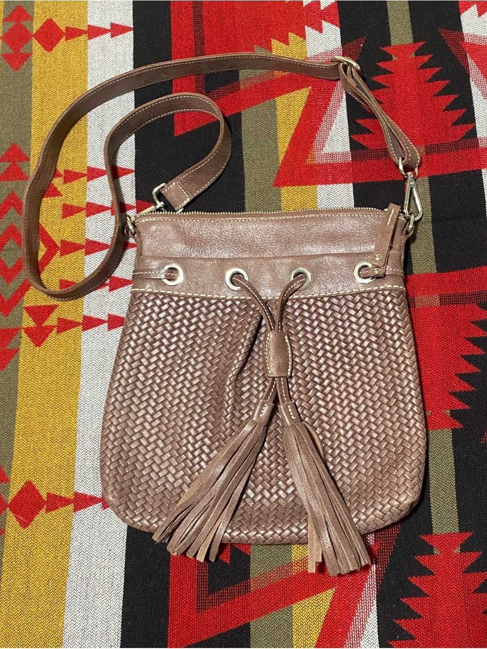 Roots Brown Woven Leather Drawstring Bucket Crossbody Bag with Tassels